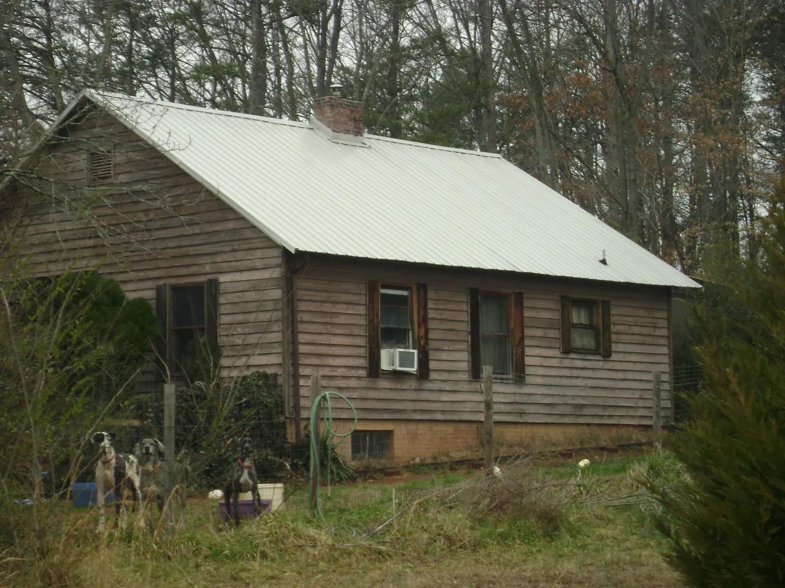 White metal roof on an old wood sided farmhouse, from a Asphalt Shingle Roof Repair job in Warrenton